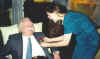 Pegge pins rose on Bill's lapel,
Friday evening.